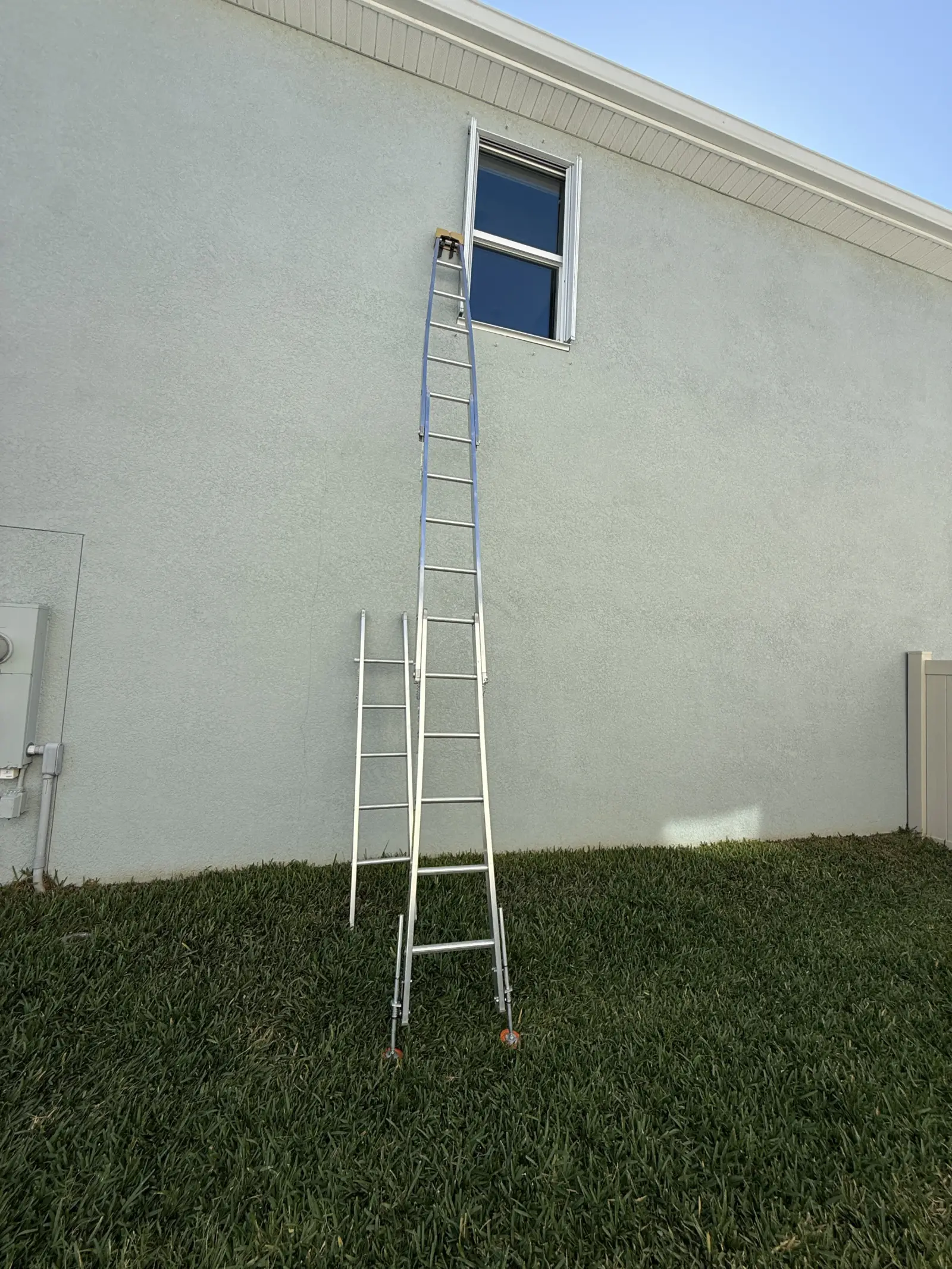 Ladder set up to a second-floor window on an Odessa home