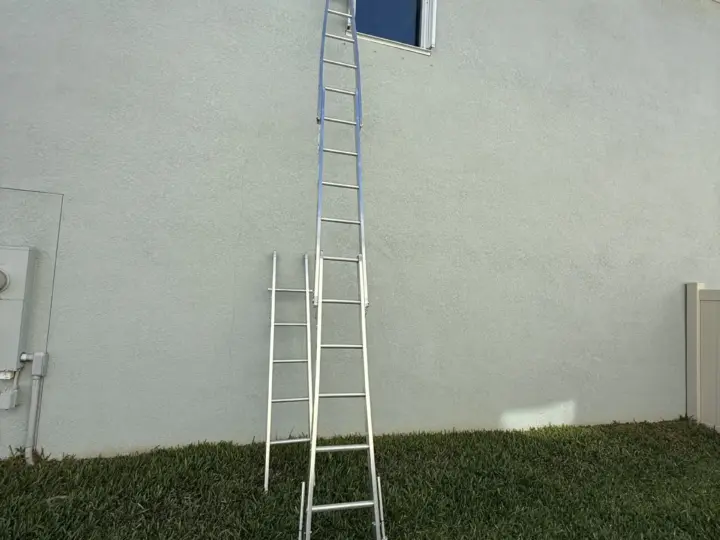 Ladder set up to a second-floor window on an Odessa home