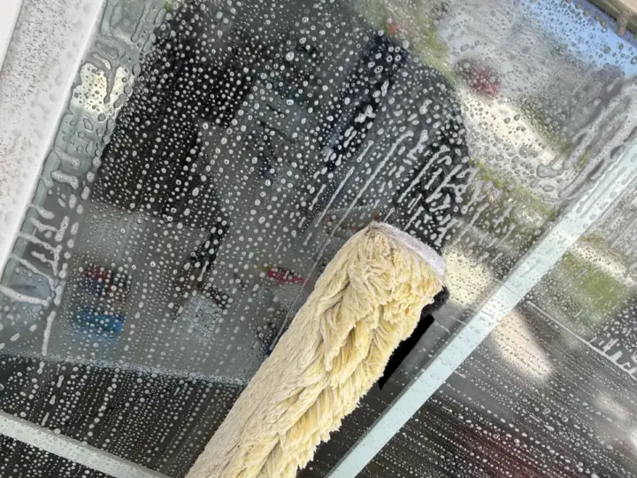 Scrubbing a window with soapy water in Odessa