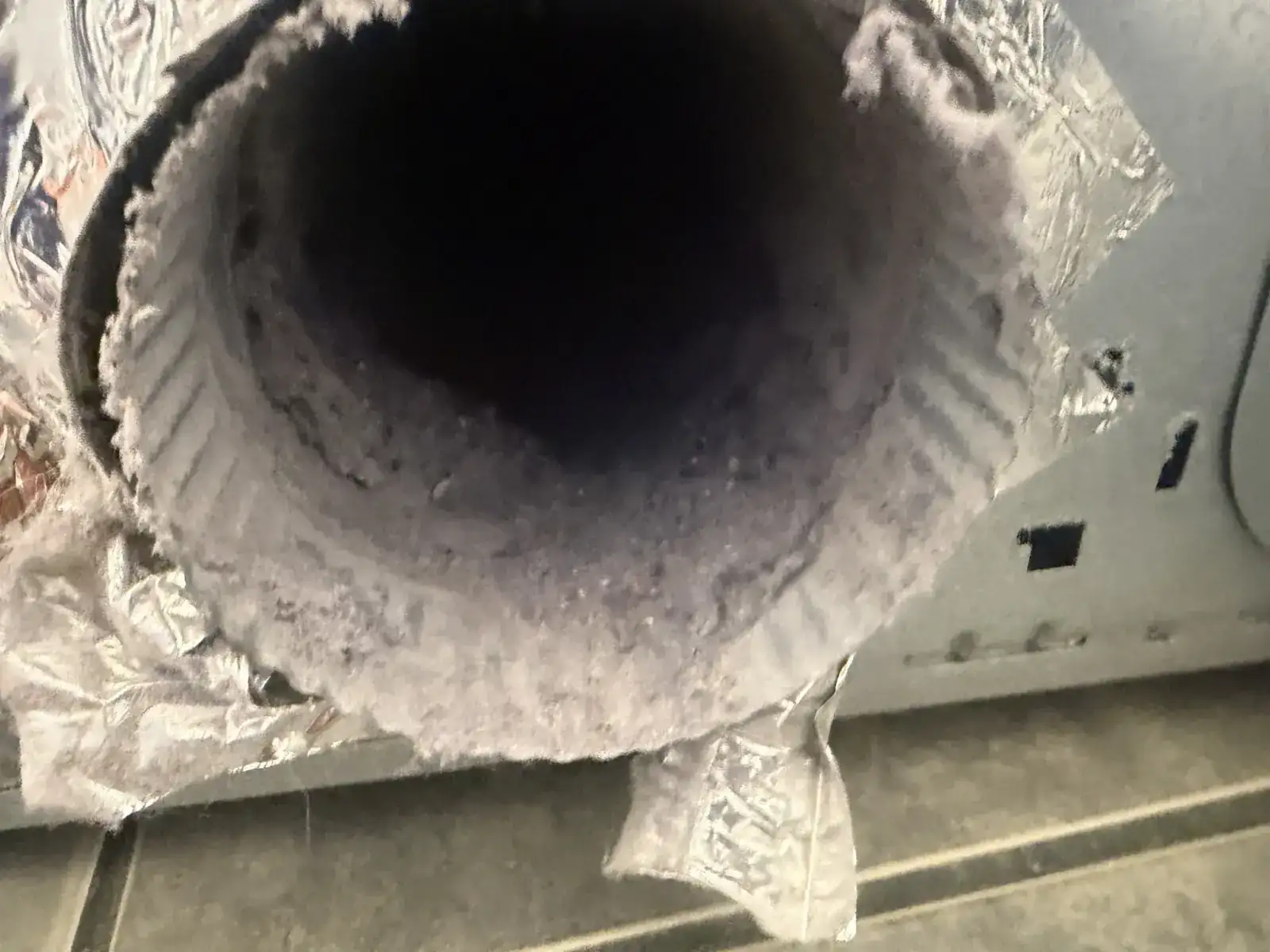 A dryer duct lined with lint, before cleaning (Land O' Lakes)