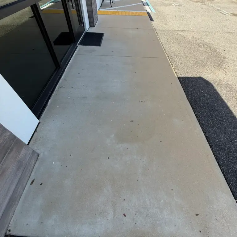The same entry walkway after pressure washing, with clean, even concrete