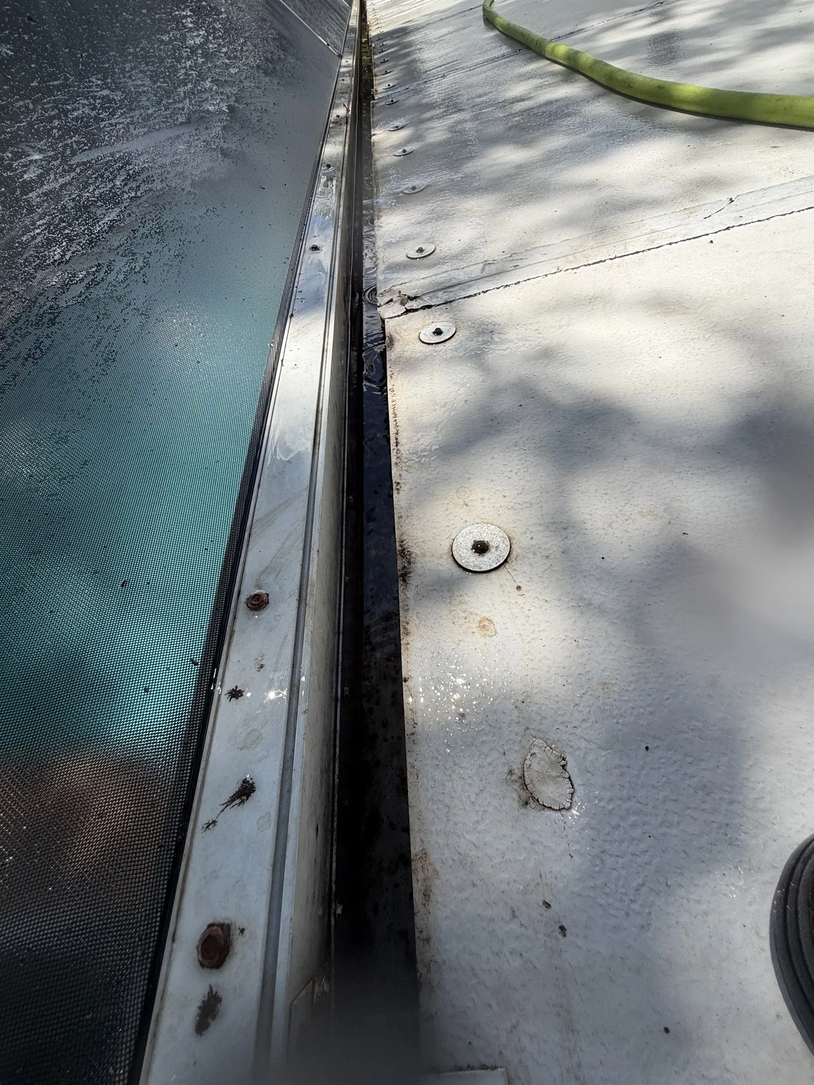 The same gutter beside the pool enclosure after cleaning, clear and rinsed