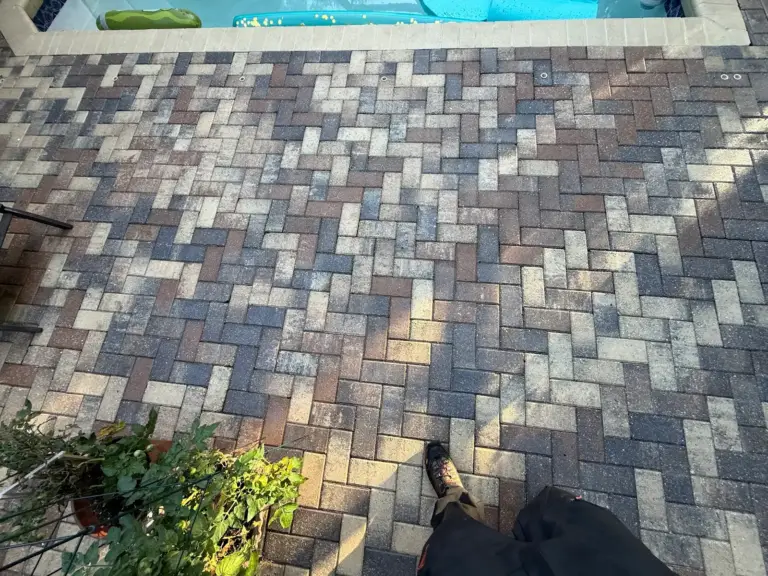 Clean brick paver pool deck in Oldsmar, FL after pressure washing