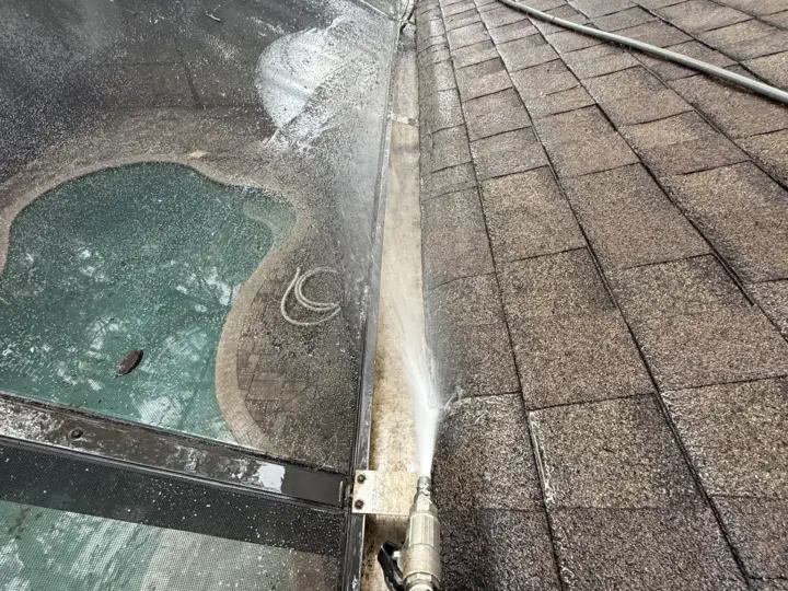 Rinsing the pool cage panels above the pool (South Tampa)