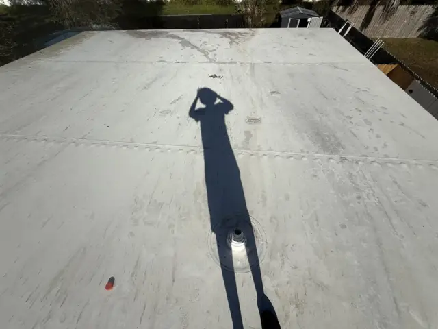Stained white roof seams before cleaning