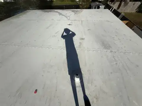 Stained seams on a white roof, before cleaning