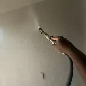 Soft washing the stucco walls of a covered porch
