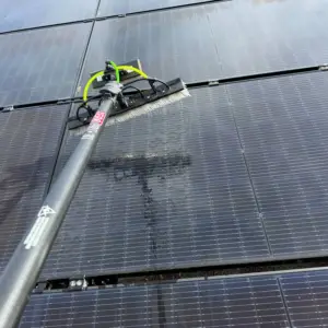 Water-fed brush pole cleaning residential solar panels in Tampa, FL