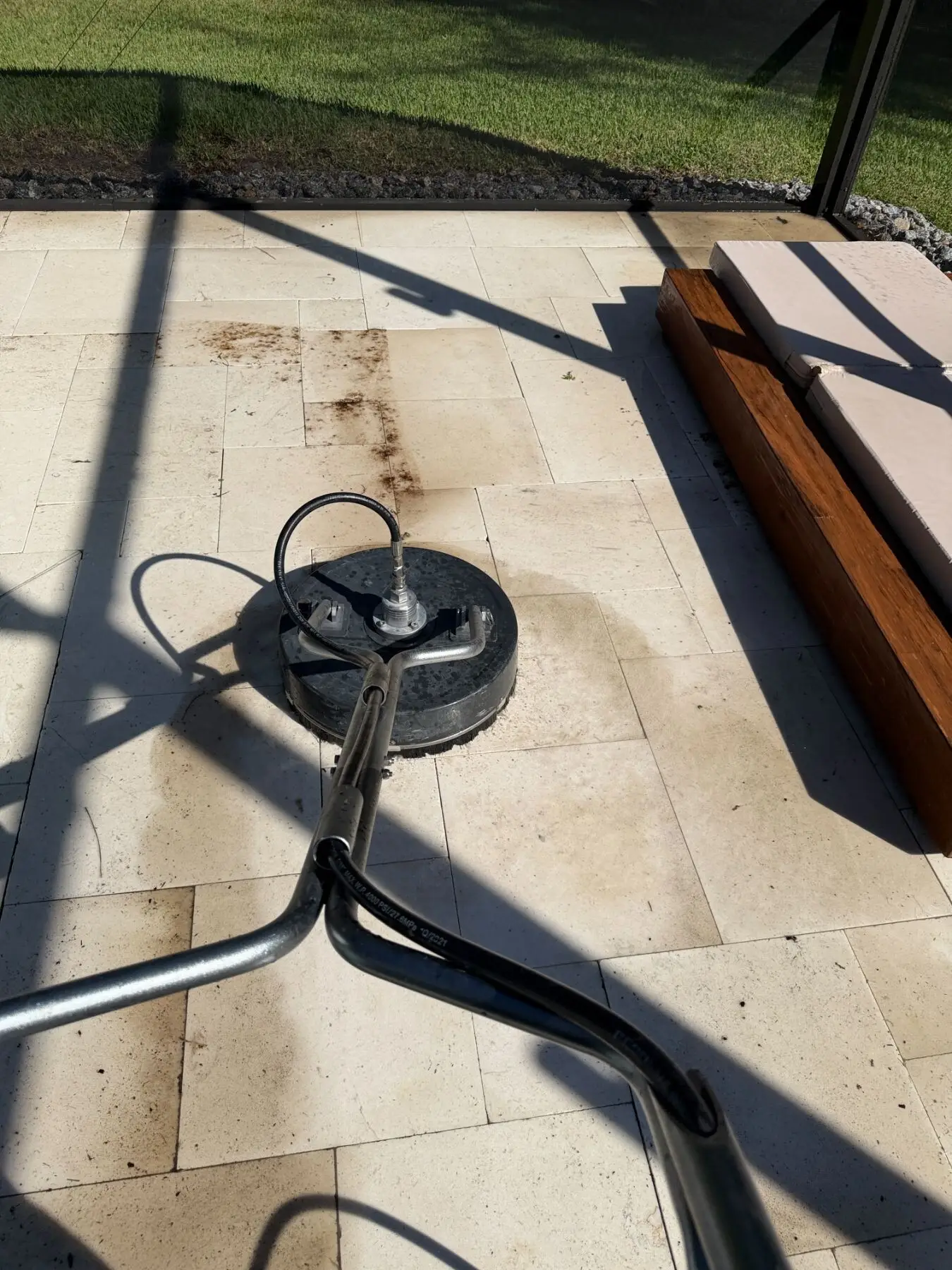 Surface cleaner removing algae from a travertine pool deck in Lutz, FL