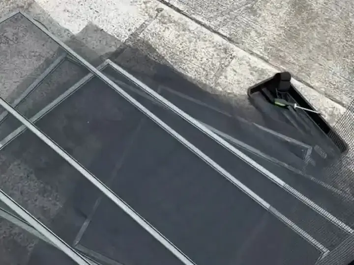 Screen frames stripped of old mesh on the driveway, New Port Richey