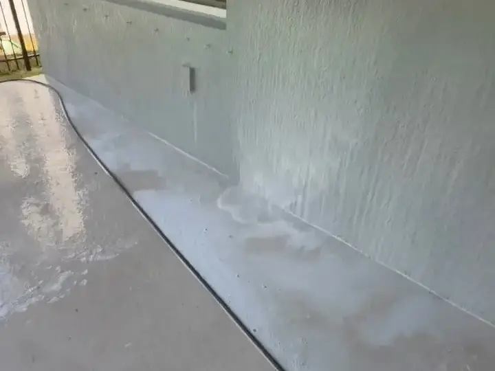 Rinsing the wall of a covered back porch in Riverview