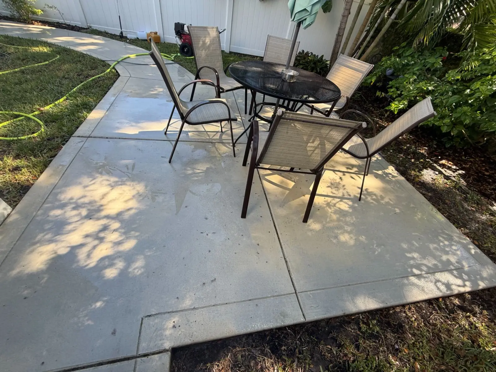 The same concrete back patio in Tampa, FL, after pressure washing
