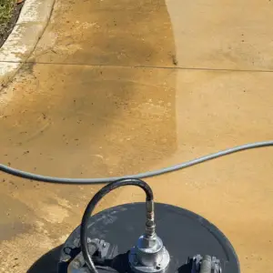 Surface cleaner leaving a clean stripe on a stained concrete driveway in Tampa, FL