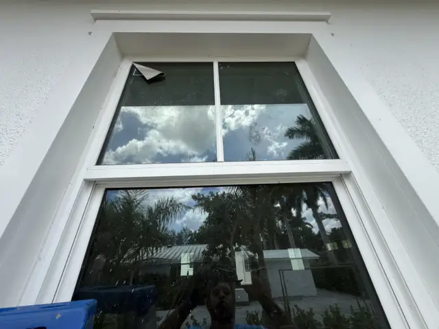 Picture window with a factory sticker, before cleaning