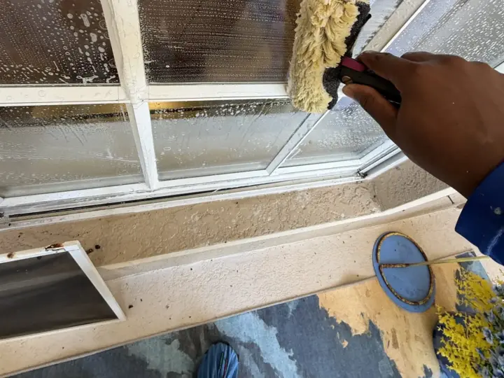 Working on the glass with shoe covers on to keep the floor clean (Land O' Lakes)