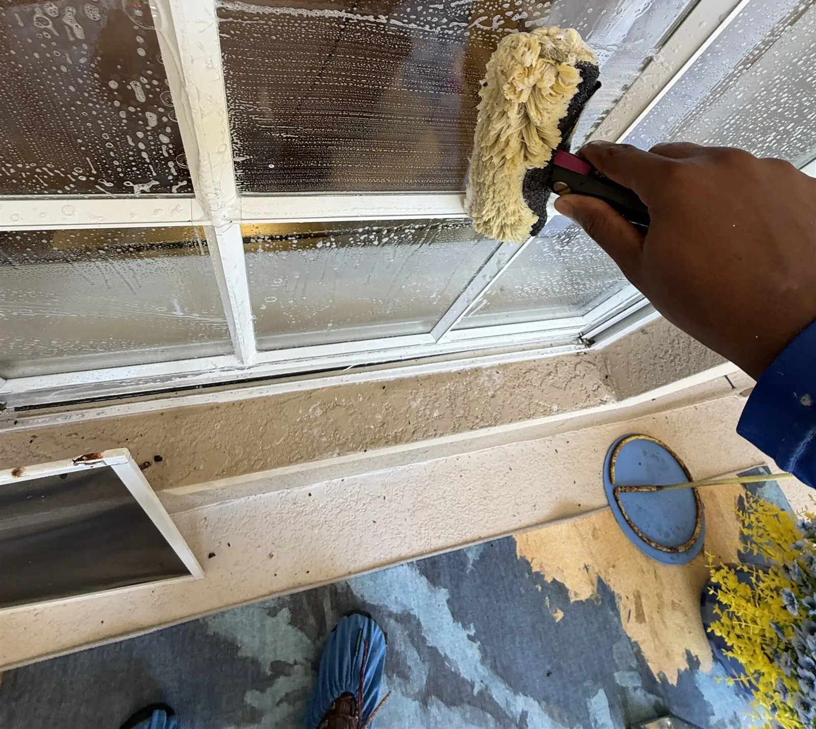 Working on the glass with shoe covers on to keep the floor clean (Land O' Lakes)