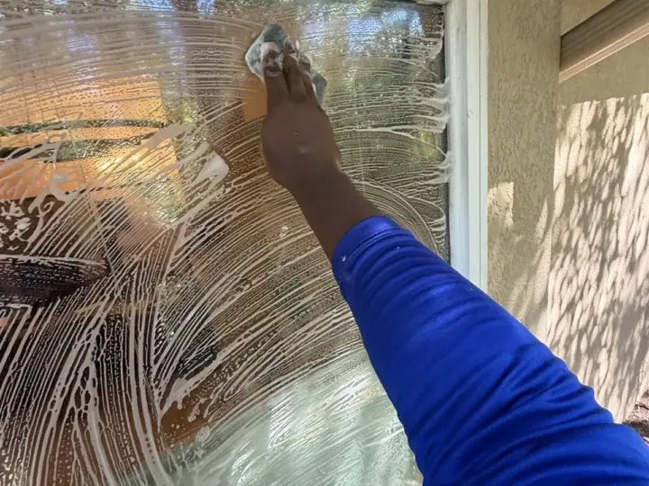 Scrubbing the outside of a window before it is cleaned (Land O' Lakes)